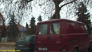 Girl peeing between the cars