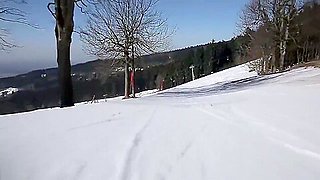 Woman skiing naked and masturbating lying on the snow