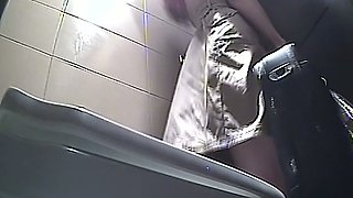 Brunette amateur white woman pisses in the toilet on hidden cam
