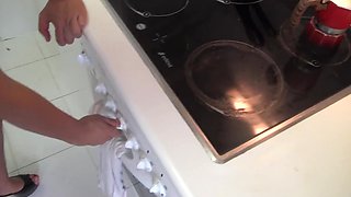 Brunette Housewife gives a quick blowjob to her husband in the kitchen