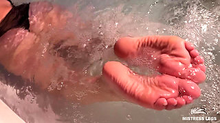 Mistress Teases in the Jacuzzi with Bare Wrinkled Feet and Delicious Ass