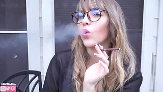 Mila enjoys her menthol cigarettes outside while rocking glasses and a secretary vibe
