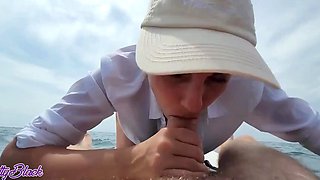 Naughty bitch makes a public blowjob while floating in a boat on the sea.