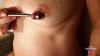 nippleringlover horny milf inserting 16mm metal beads in extreme stretched nipple piercings