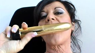 In a kitchen a sexy brunette playing with her big boobs