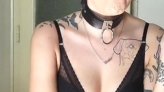 Tattooed gothic lady smoking in the kitchen