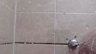 The camera is watching a mature chubby milf in the shower. Gorgeous fat ass, big natural boobs, hairy pussy. PAWG.