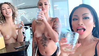 In a kitchen a sexy brunette playing with her big boobs