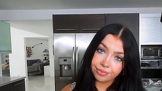 Young dame with small breasts in kitchen