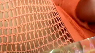 Glass Dildo Solo in an Orange Fishnet Bodysuit - Busty Brunette Plays on the Couch