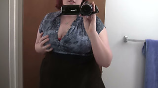 Busty Redhead in Glasses Films Herself Naked in the Bathroom Mirror