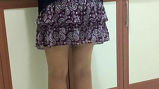 Mature woman in sheer stockings doing housework in the kitchen.