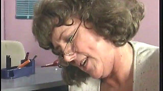 Mature brunette sucks and takes cock by desk at work