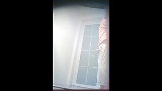 Chinese college girl taking a shower in the drom bathroom.