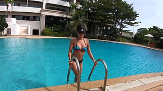 Thick Thai bombshell flaunts her phony funbags in a skimpy swimsuit