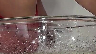 A MILF in Red Is Peeing Into a Basin.