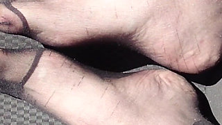 Feet of Nylonjunge in Pantyhose in Car