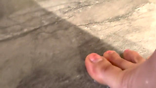 Anong Cleans the Bathroom Floor with Her Soaked Hoodie, on Her Knees.