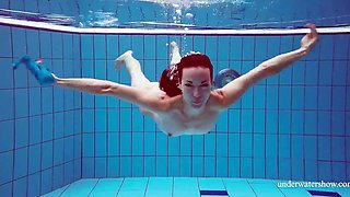 Skinny girl out in the pool cosplaying nirvana album cover underwater