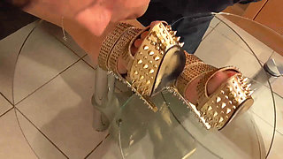 Mistress lets her slave lick her golden shoes