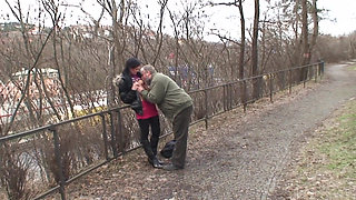 It's cold in the park and the young brunette with small natural tits gets warmed up by an old man and swallows all the cum