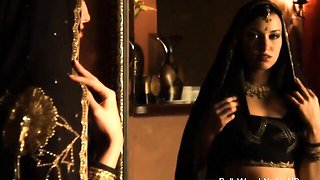 Warm light on a bindi and maang tikka as she sits nude with long black hair