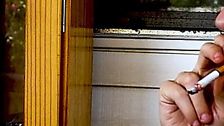 Shaved Head Goth Smokes Outside