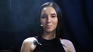 Elegant Brunette Smoking in Black Outfit