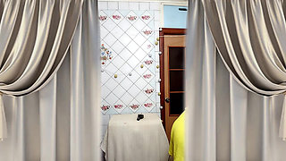 Cheerful housewife Lukerya undresses in the kitchen after cleaning.