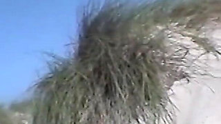 A hairy teen shoots her boyfriend with a camera on the beach